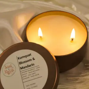 Lit candle with Kumquat Blossom and Mandarin label.