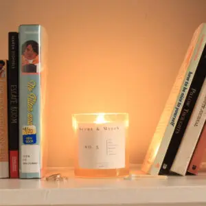 Books and candle on a shelf.