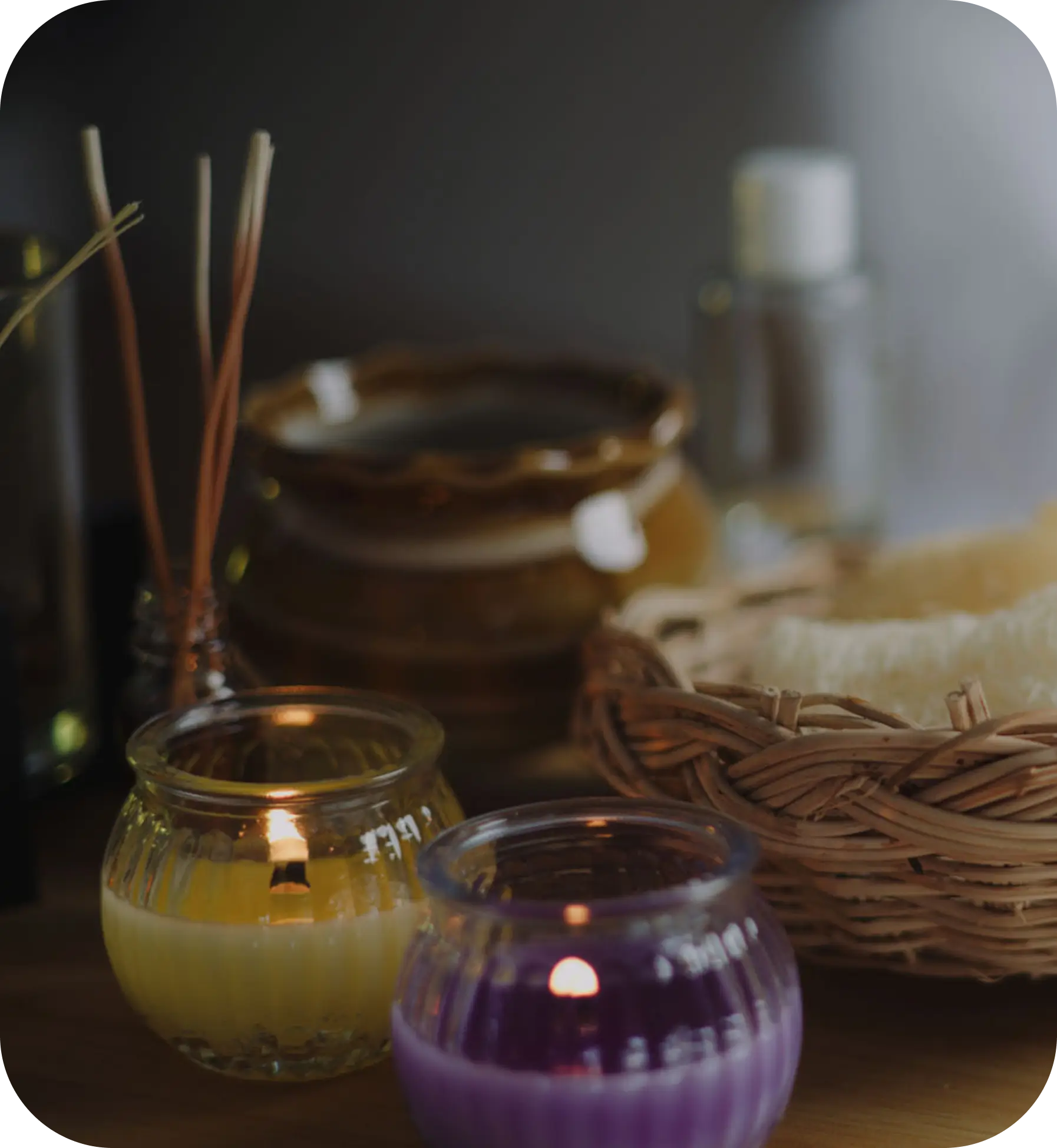 Candles and basket on a wooden table.
